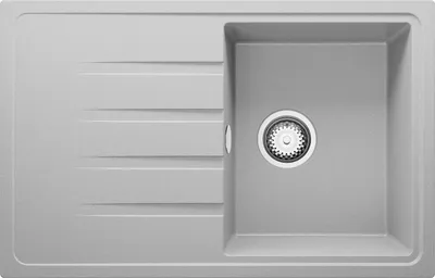 A top-down view of a gray granite kitchen sink with a single basin and a drainer area with grooves.
