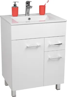 A white bathroom vanity with a sink, faucet, soap dispenser, and toothbrush holder.