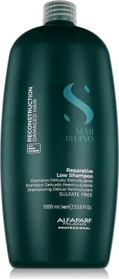 A dark teal bottle of Alfaparf Semi Di Lino Reconstruction Reparative Low Shampoo against a white background.