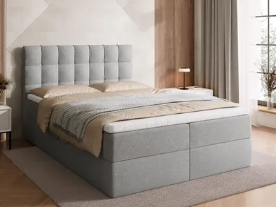 A bedroom scene with a bed as the main focus.