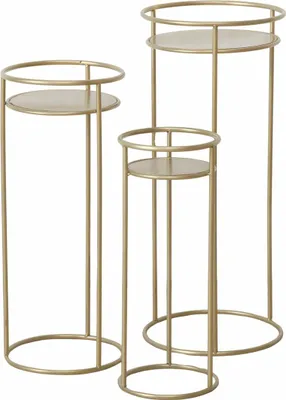 Three gold metal plant stands of varying heights.