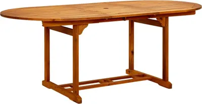 A wooden oval dining table on a white background.
