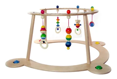A wooden baby activity gym with hanging toys.