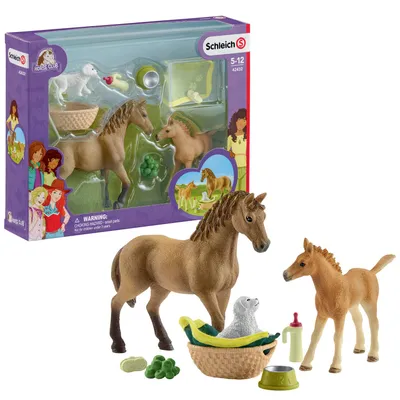A toy playset featuring horses, a dog, and accessories, displayed in its original packaging.