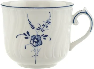 A white ceramic cup with a blue floral design and a blue rim.