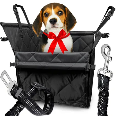 A beagle puppy wearing a red bow sits in a black dog car seat. Accessories for the car seat are shown next to it.