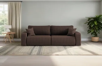 A brown sofa is placed in a living room setting with a rug, a plant, and a window with curtains.