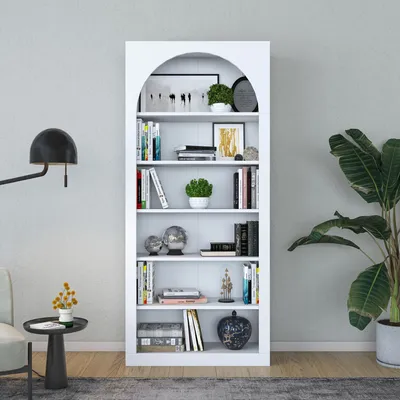 A white bookshelf filled with books and decorative items, placed against a light gray wall.