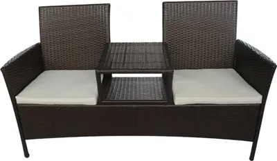A brown rattan sofa with white cushions and a central table.
