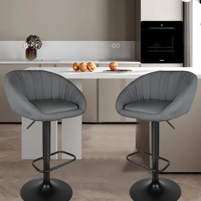 Two dark gray bar stools are shown in a modern kitchen setting.