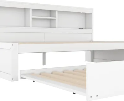 A white daybed with a pull-out trundle bed and storage compartments in the headboard.