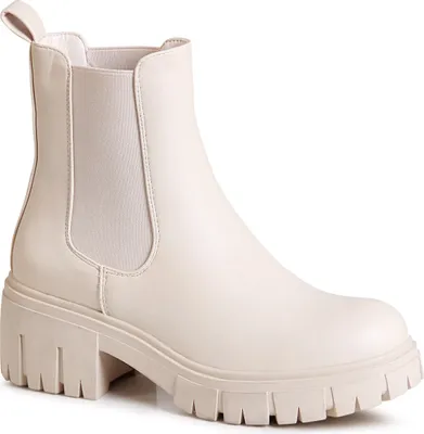 A single beige Chelsea boot with a platform sole is shown against a white background.