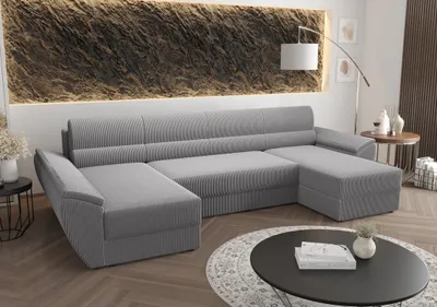 A U-shaped sofa in a modern living room setting with a textured wall and a coffee table.