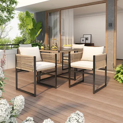An outdoor patio setting with a dining set and plants.