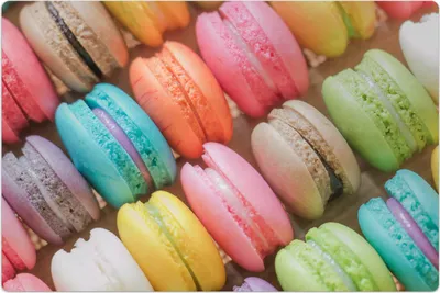 A close-up overhead view of a collection of colorful macarons.