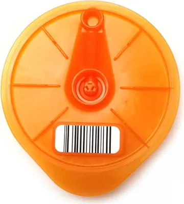 A top-down view of an orange plastic disc with a barcode sticker.
