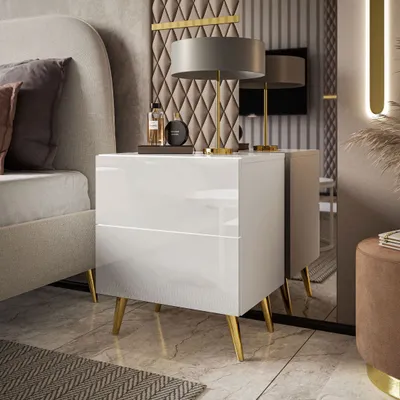 A modern bedroom setting with a nightstand next to a bed.