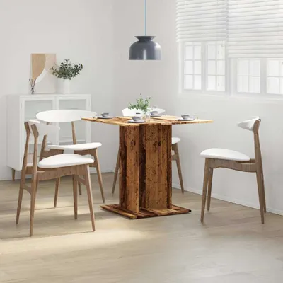 A dining room scene with a wooden table and chairs.