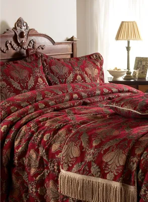 A luxurious bedroom setting with a richly patterned bedspread.