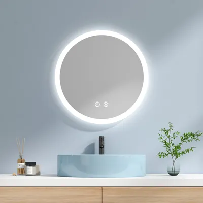 A modern bathroom vanity with a round, illuminated mirror above a light blue sink.