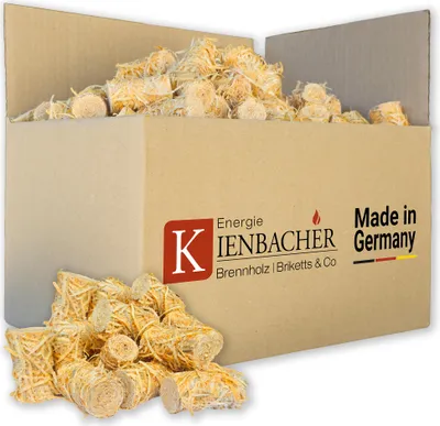 A cardboard box filled with wood wool fire starters, with some scattered in front of the box.