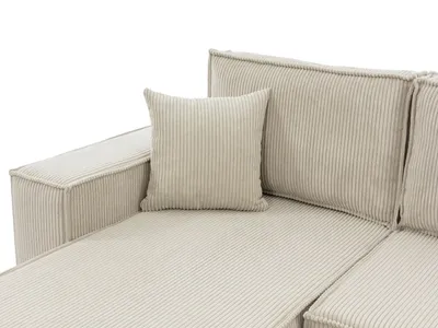 A close-up view of a beige corduroy sofa section with a throw pillow.