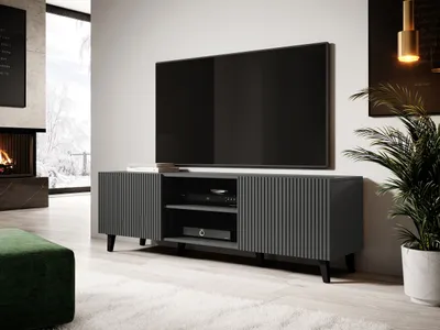 A modern living room with a TV stand, fireplace, and plant.