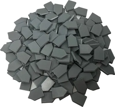 A pile of small, grey, pentagonal building blocks.