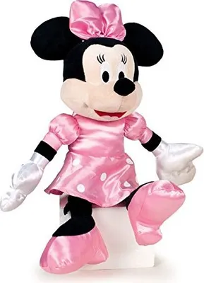 A plush toy of Minnie Mouse sitting on a white cube.