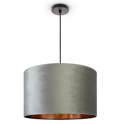 A pendant light with a gray velvet shade and a copper interior, suspended from a black cord attached to a black ceiling mount.