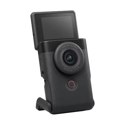 A black compact camera with its screen flipped up, shown against a white background.