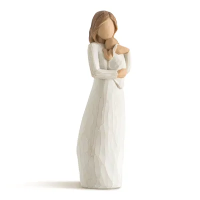 A figurine of a woman holding a baby.