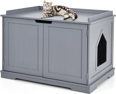 A grey wooden cat litter box enclosure with a cat lying on top.