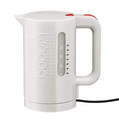 A white Bodum electric kettle with a beige handle and red accents, shown against a white background.