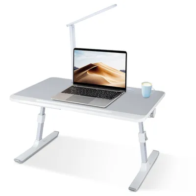 A foldable laptop table with an adjustable LED lamp and a cup on it, set against a white background.