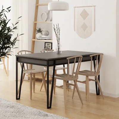 A dining table and chairs set in a well-lit room with a ladder shelf and wall decor.