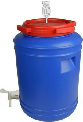 A blue plastic fermentation barrel with a red lid and a spigot.