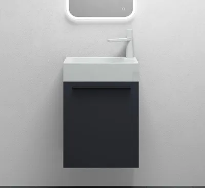 A modern bathroom vanity with a sink and faucet against a textured wall.