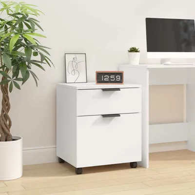 A white mobile filing cabinet with two drawers is shown in a room with a plant and a computer desk.