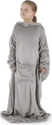 A young girl wearing a gray blanket with sleeves.