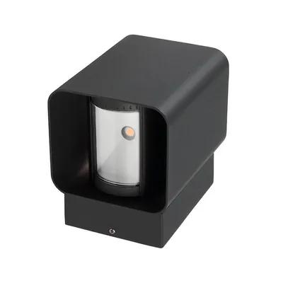 A black outdoor light fixture with a clear glass enclosure and an orange light source visible inside.