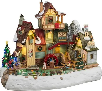 A festive, snow-covered miniature village scene featuring a grist mill, Christmas trees, and various woodland creatures.
