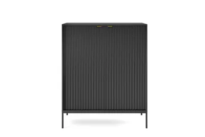 A black cabinet with fluted doors and gold handles stands on thin black legs against a white background.