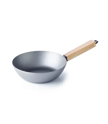 A wok with a wooden handle on a white background.
