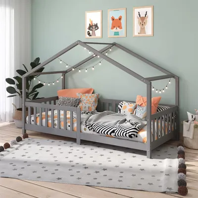 A child's bedroom with a house-shaped bed.