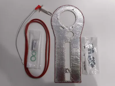 A collection of parts laid out on a white surface.