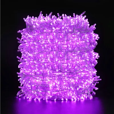 A tightly wound coil of purple LED string lights against a black background.