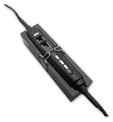 A black aviation headset control unit is shown resting in a black holder.