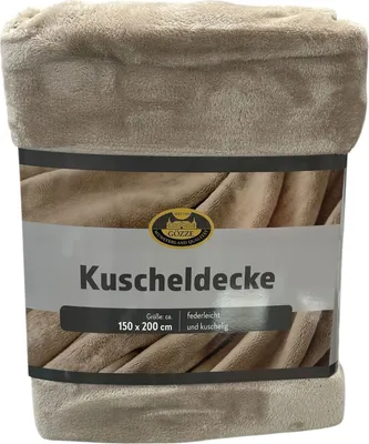 A folded blanket with a product label.