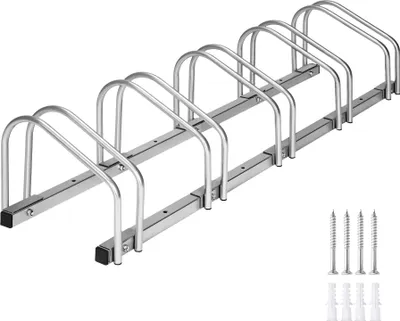 A bicycle rack with multiple slots for parking bicycles, shown on a white background. Screws and wall plugs are visible in the bottom right corner.
